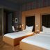 Amadi Park Hotel Amsterdam room with two beds, desk and sliding glass door