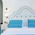 Albergo Sant'Andrea in Amalfi bedroom with twin blue-striped pillows and scalloped headboard