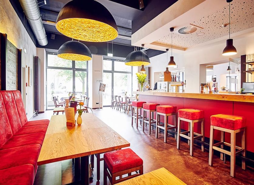 Djh Jugendgästehaus Adolph Kolping Dortmund bar and lounge with red stools and bright seating area