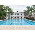 La Joya Del Lago in Ajijic with a large outdoor pool and palm trees facing the hotel