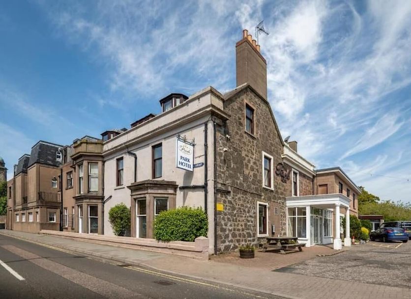 Park Hotel in Montrose, stone-front hotel exterior with entrance and parked cars on the street