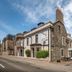 Park Hotel in Montrose, stone-front hotel exterior with entrance and parked cars on the street