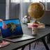 Moxy Milton Keynes desk with laptop, globe, drinks and pink headphones in a stylish guest room