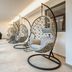 Romantik Hotel Hirschen in Parsberg: corridor with hanging wicker egg chairs and floor-to-ceiling windows