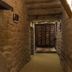Posada Mayor de Migueloa in Laguardia: stone hallway with arched ceiling and wooden gate