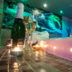 Sojka Resort in Malatiny spa bath with champagne and candles beside a waterfall mural