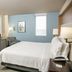Holiday Inn Metairie New Orleans guest room with king bed, desk and chair