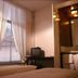 De Utrechtsche Dom Gouda guest room with twin beds, window curtains, and a small TV