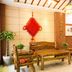 Education Hotel Guilin lobby with wooden seating, red wall decor, and warm lighting