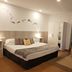 Campomar Playa room in El Puerto de Santa María with double bed, wardrobe and window with curtains