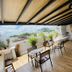 Ocean Breeze Santo Domingo rooftop terrace with seating, plants and city views