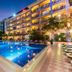 Somadevi Angkor Premium in Siem Reap with illuminated outdoor pool and hotel facade at dusk