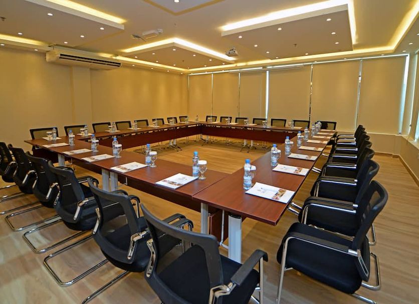 Emirates Stars Hotel Apartments Dubai meeting room with U-shaped conference table and black chairs