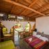 La Casa de Sebas in Máncora guest room with rustic wood ceiling, bunk beds and patio view