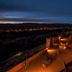 Kasbah Tizzarouine in Boumalne Dadès with a lit terrace overlooking a valley at night