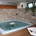 Residence Ruetoreif indoor hot tub in Gressoney-Saint-Jean with stone walls and wood decking