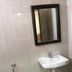 Vrp Guest House Bhuj bathroom with wall-mounted sink and mirror