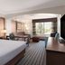 La Quinta Inn & Suites by Wyndham Bakersfield North guest room with king bed, desk, and window seating in Bakersfield