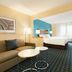 Fairfield Inn by Marriott Kankakee Bourbonnais guest room with bed, sofa, desk, and window seating in Bourbonnais