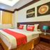 OYO 389 Sira Boutique Residence in Patong, guest room with double bed, TV and window with curtains