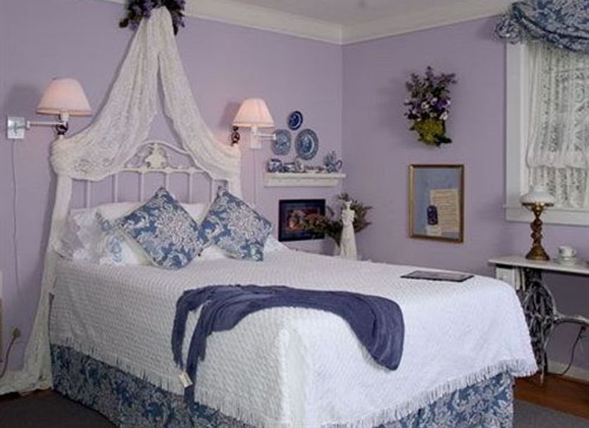 The Garden Walk Bed & Breakfast in Lookout Mountain: lavender bedroom with canopy bed and lace drapery