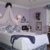 The Garden Walk Bed & Breakfast in Lookout Mountain: lavender bedroom with canopy bed and lace drapery