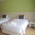 Baan Klang Hua Hin room with two twin beds and green patterned wall in Hua Hin
