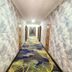 Long Ge Hotel Beijing hallway with geometric wallpaper and patterned carpet
