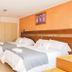 Hotel Serena Suite in La Serena guest room with two twin beds and wood accent wall
