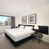 The York by Swiss-Belhotel in Sydney guest room with king bed and city view through large window