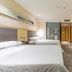 City Comfort Inn Foshan Zumiao Zhangcha guest room with two beds, TV, desk and glass bathroom