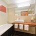 Hotel Alpenland in Sankt Anton am Arlberg bathroom with bathtub, wall-mounted shower, and vanity sink