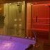 Château de la Caze in Gorges-du-Tarn-Causses: lit indoor hot tub beside a glass sauna and steam room