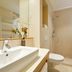 Flottwell Berlin Hotel bathroom with sink, toilet, and shower in Berlin