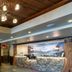 Cedar Creek Lodge And Conference Center in Columbia Falls lobby with stone fireplace and front desk