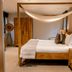 Norfolk Mead Norwich bedroom with four-poster bed, canopy drape and wood furnishings