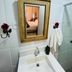 Hospedagem Central in Tiradentes bathroom sink with gold-framed mirror and towel rack