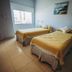 Tagüe in Gualeguaychú: twin bed guest room with window light, bedside tables and wall art