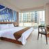 Midtown Hotel Surabaya guest room with city view, king bed, desk and TV