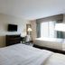 Copley Inn & Suites By OYO Akron Oh in Copley: guest room with two beds, TV, desk and window view