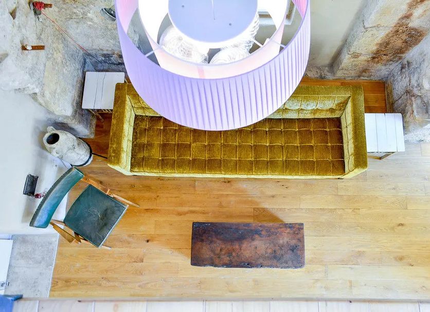 Villa Olivia, Split: overhead view of a sunken lounge with gold sofa, wood floor and circular ceiling feature
