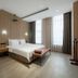 Haobo International Hotel in Wuxi guest room with king bed, bench and floor-to-ceiling windows