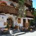 Pension Leopoldine in Hallstatt with flower-filled wooden balconies and outdoor café seating