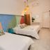 Hotel Barahona Cartagena guest room with two beds and colorful mural wall in Cartagena