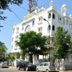 OYO 7152 Gumaan Heritage in Jaipur, a white heritage-style hotel building with arched windows and trees outside