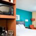 Fairfield Inn & Suites by Marriott South Bend Mishawaka room with bed, bedside lamp and in-room microwave