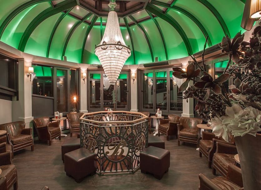 Europa Hotel Kühlungsborn lounge with green domed ceiling, chandelier, and seating area in Kuehlungsborn