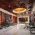 Power Valley International Hotel in Baoding fitness center with treadmills, weights and chandelier ceiling