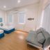 Brisa Marina Beach Resort in Morong room with two beds, sofa, wall fish decor and bright windows