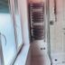 L'Affittacamere di Venezia bathroom in Venice with shower, pink sink, and heated towel rail
